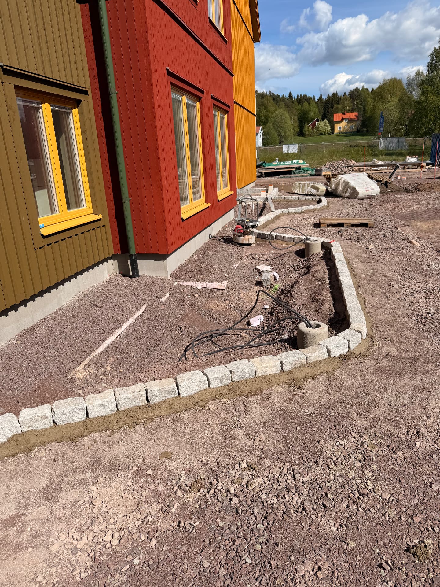 Färdigsatt storgatsten i mjuk kurva längs byggnaden